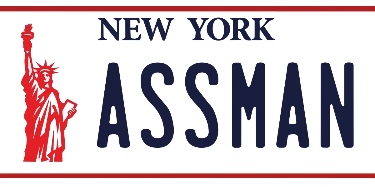 Assman license plate sticker: a white New York plate with a red Statue of Liberty and navy ASSMAN lettering